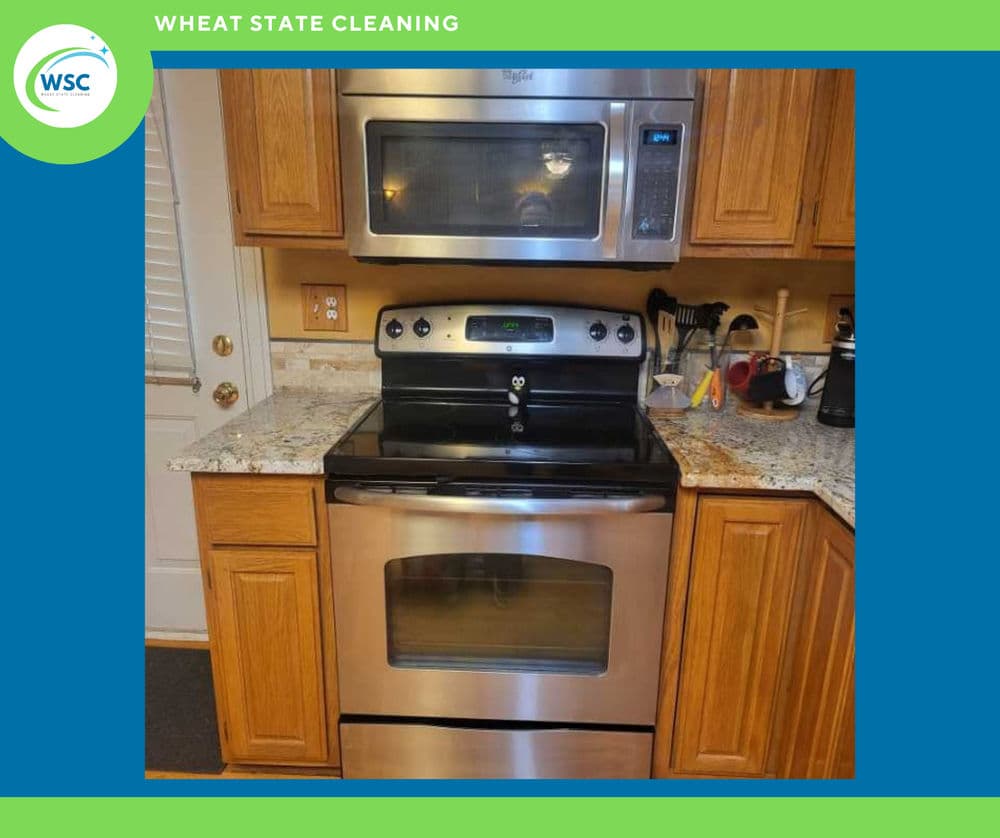 Modern stainless steel kitchen appliances with granite countertop and wooden cabinets.