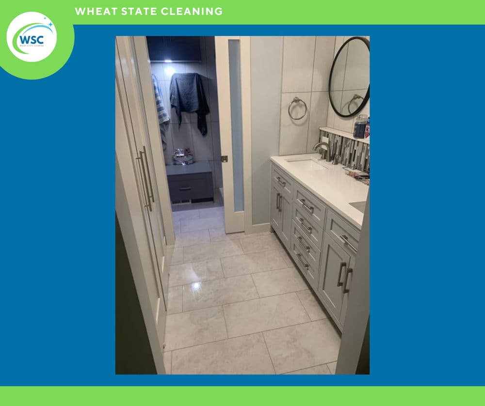 Modern bathroom interior with white cabinetry, marble tile floor, and stylish fixtures.