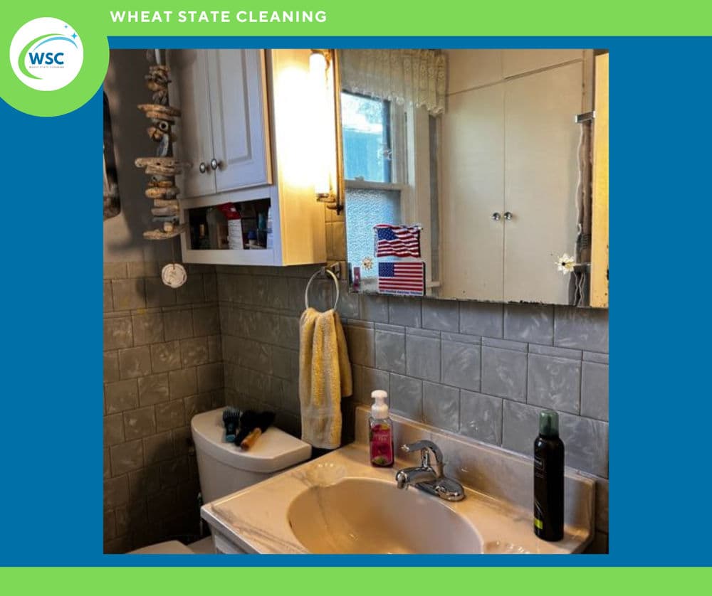 Clean bathroom with sink, mirror, towels, and decor, featuring Wheat State Cleaning branding.