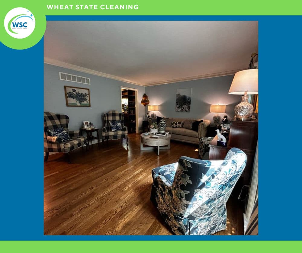 Living room with blue walls, hardwood flooring, patterned chairs, and a cozy atmosphere.